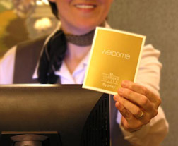 staff member with welcome card